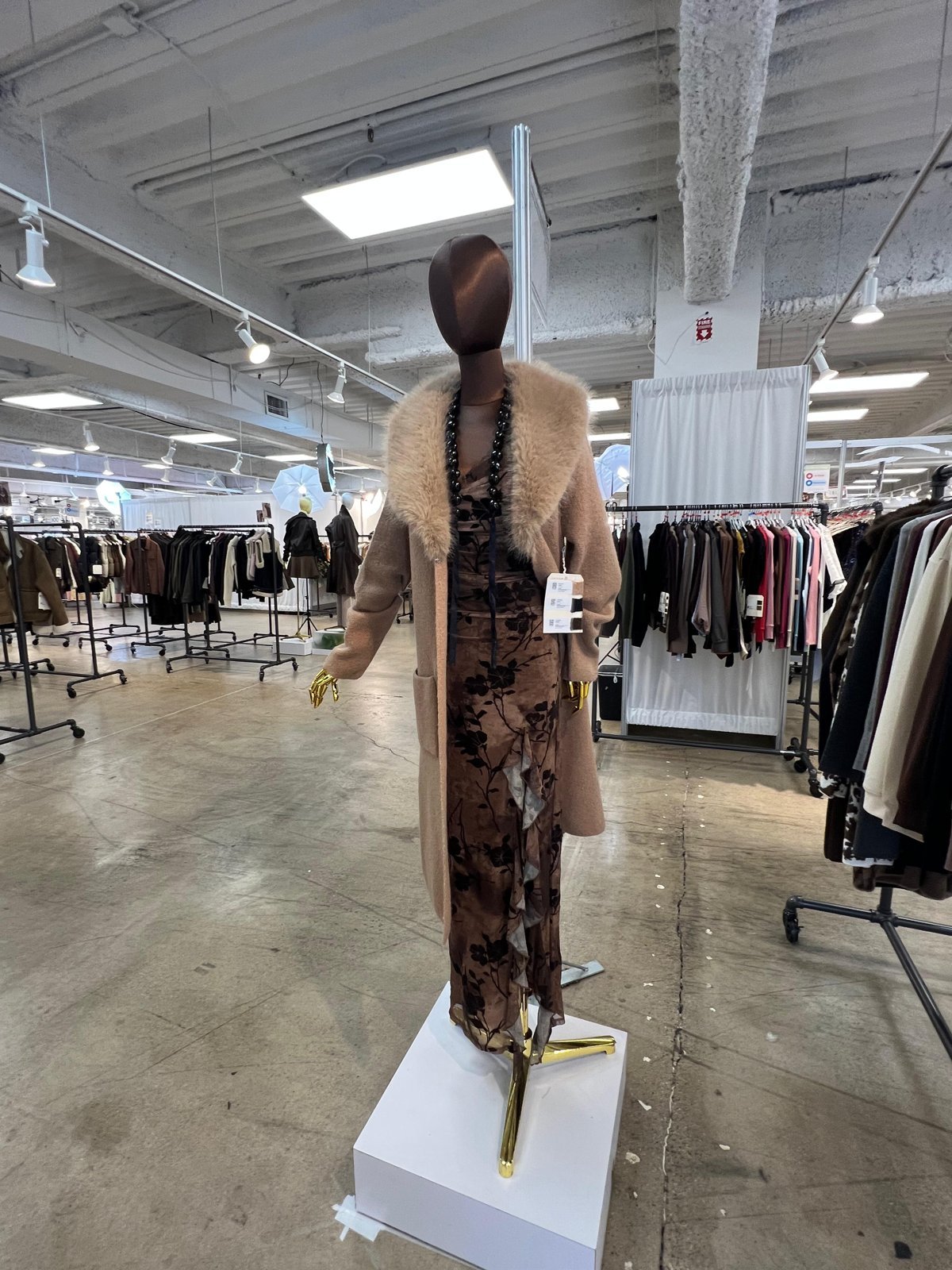 Camel coat with faux fur collar over a floral midi dress