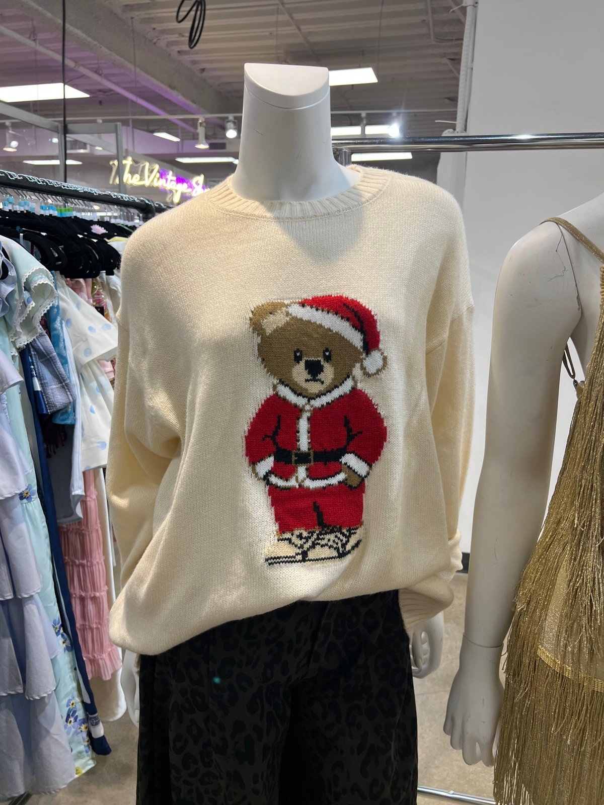 Cream sweater with a teddy bear in a Santa outfit