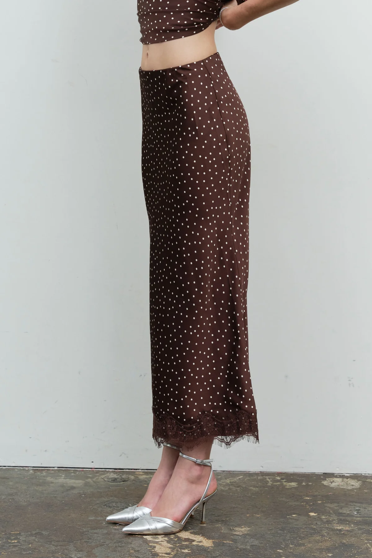 Brown polka dot satin midi skirt with lace hem, side view