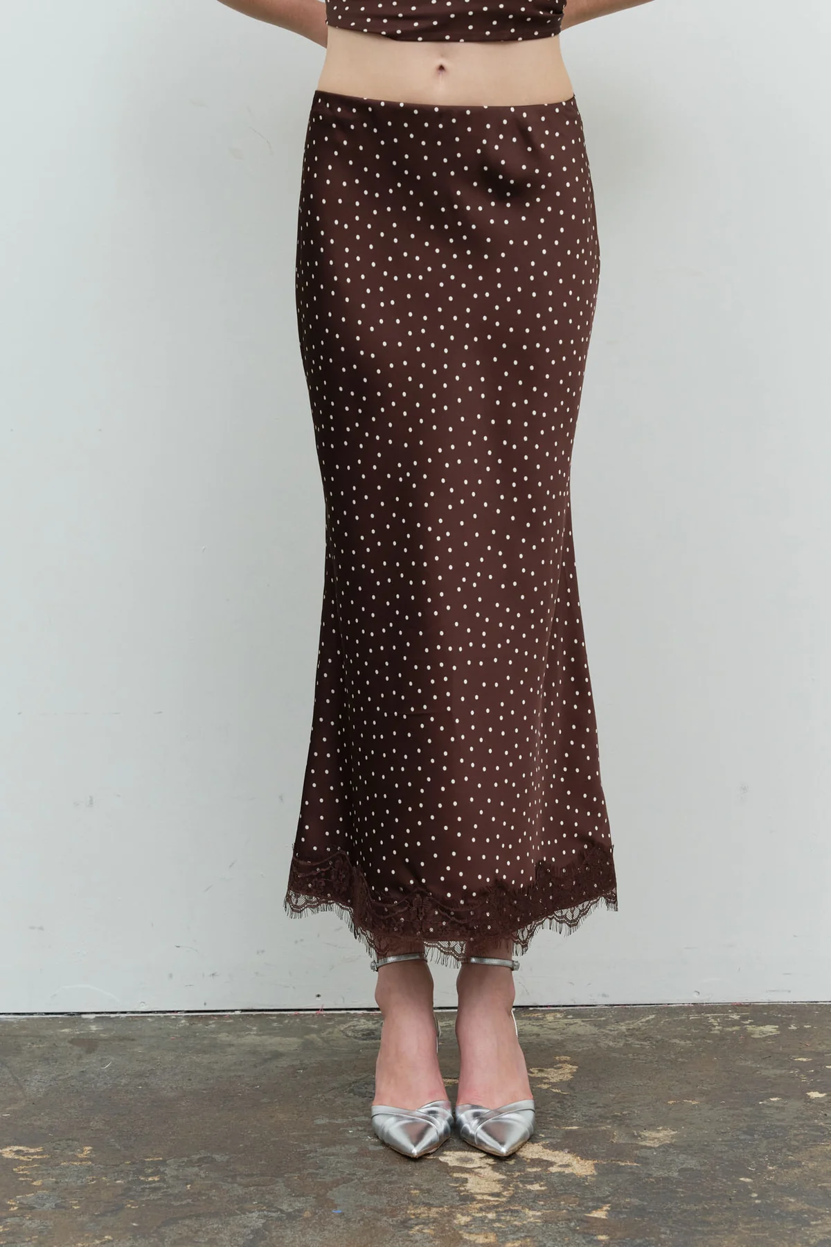 Brown polka dot satin midi skirt with lace hem, front view